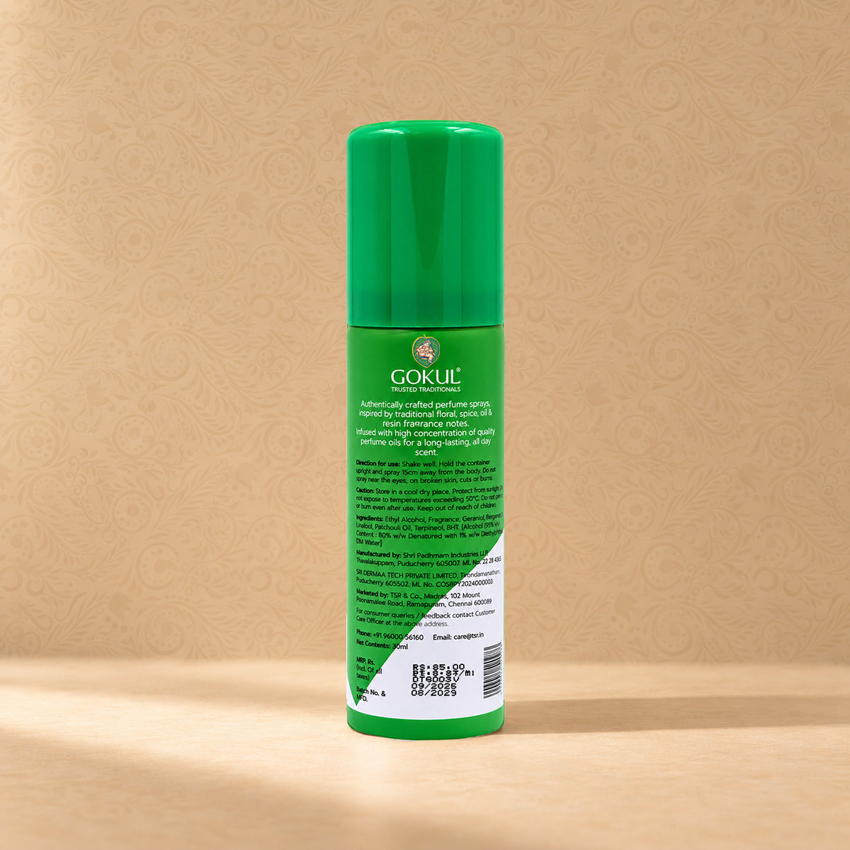 A green bottle of Gokul Hair Care product, showing the back label, set against a warm beige patterned background.
